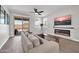 Comfortable living room with a stylish fireplace, neutral-toned sofa, and sliding glass doors to the outdoor patio at 31435 N 130Th Ave, Peoria, AZ 85383