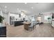 Open-concept living space featuring a modern kitchen, dining area, and comfortable living room with lots of natural light at 31435 N 130Th Ave, Peoria, AZ 85383