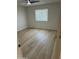 Spacious bedroom with wood-look floors and a neutral palette offers versatility and comfort at 3225 E Monica Ave, Phoenix, AZ 85032