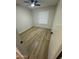 Empty bedroom with a ceiling fan, wood-look floors, and neutral walls creates a blank canvas at 3225 E Monica Ave, Phoenix, AZ 85032