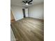 This bedroom features wood-look floors, a ceiling fan, and a closet, offering simple comfort at 3225 E Monica Ave, Phoenix, AZ 85032