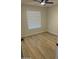 Well-lit bedroom features wood-look floors and a neutral color scheme for a tranquil atmosphere at 3225 E Monica Ave, Phoenix, AZ 85032