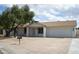 Charming single-story home featuring desert landscaping, mature trees, and a two-car garage in a peaceful neighborhood at 3225 E Monica Ave, Phoenix, AZ 85032