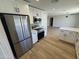 Modern kitchen boasts stainless steel appliances, white cabinets, and wood-look floors, offering a stylish cooking space at 3225 E Monica Ave, Phoenix, AZ 85032