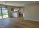 Open-concept kitchen with modern appliances, white cabinetry, and wood-look flooring at 3225 E Monica Ave, Phoenix, AZ 85032