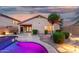Private backyard featuring desert landscaping, lighting, manicured shrubbery and a sparkling pool at 3379 E San Pedro Ave, Gilbert, AZ 85234