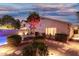 The backyard features desert landscaping, an iron bench, and lighting at 3379 E San Pedro Ave, Gilbert, AZ 85234
