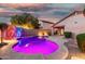 Beautiful backyard showcasing a vibrant pool, desert landscaping, and a cozy patio area at 3379 E San Pedro Ave, Gilbert, AZ 85234