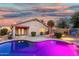 Inviting backyard with a shimmering pool, desert landscaping, and well-lit patio area at 3379 E San Pedro Ave, Gilbert, AZ 85234