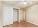 Bedroom with laminate floors, neutral wall color, and a ceiling fan and closet at 3379 E San Pedro Ave, Gilbert, AZ 85234