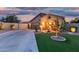 Charming single-story home boasting manicured turf and lush landscaping at twilight at 3379 E San Pedro Ave, Gilbert, AZ 85234