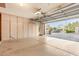 Open garage with epoxy flooring, built-in storage, and a view to the driveway and neighborhood at 3379 E San Pedro Ave, Gilbert, AZ 85234