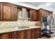Kitchen close-up showing stainless steel range hood, tile backsplash and granite countertops at 3379 E San Pedro Ave, Gilbert, AZ 85234