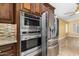 Updated kitchen with stainless steel microwave and oven and a stainless steel refrigerator at 3379 E San Pedro Ave, Gilbert, AZ 85234