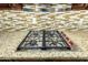 Close-up of stainless steel gas cooktop with granite countertops and custom wood cabinetry at 3379 E San Pedro Ave, Gilbert, AZ 85234