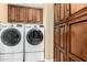 A well-equipped laundry room features two sets of LG washers and dryers with dark wood cabinets at 3379 E San Pedro Ave, Gilbert, AZ 85234