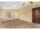 Open-concept living room featuring neutral walls, tile floors, and shuttered windows at 3379 E San Pedro Ave, Gilbert, AZ 85234
