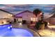 Backyard pool with rock landscaping and decorative lighting at 3379 E San Pedro Ave, Gilbert, AZ 85234