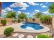 Backyard pool surrounded by desert landscaping and mature trees at 3379 E San Pedro Ave, Gilbert, AZ 85234