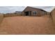 Spacious backyard view highlighting the home's exterior, covered patio, and block fence, creating a blank canvas for landscaping at 361 S Calle Miguel --, Casa Grande, AZ 85194