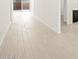 Bright hallway featuring wood-style tile floors and neutral walls, leading to a glass sliding door at 361 S Calle Miguel --, Casa Grande, AZ 85194