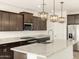 Bright kitchen features stainless steel appliances, granite countertops, and stylish dark wood cabinets at 361 S Calle Miguel --, Casa Grande, AZ 85194
