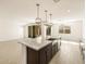 Spacious open kitchen featuring a center island, modern lighting, and stainless appliances at 361 S Calle Miguel --, Casa Grande, AZ 85194