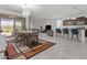 Bright dining area with modern furnishings, a stylish chandelier, and open layout flowing into the living room at 37103 N El Morro Trl, San Tan Valley, AZ 85140
