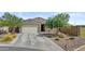 Charming single-story home with a two-car garage, desert landscaping, and a well-maintained front yard at 37103 N El Morro Trl, San Tan Valley, AZ 85140