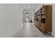 Bright hallway with neutral tile flooring, white walls, and a built-in bookshelf showcasing a modern design at 37103 N El Morro Trl, San Tan Valley, AZ 85140