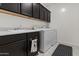 Laundry room with cabinetry, sink, washer, and dryer at 37103 N El Morro Trl, San Tan Valley, AZ 85140