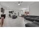 Spacious open-concept living area with a kitchen island, tile flooring, and modern furniture at 37103 N El Morro Trl, San Tan Valley, AZ 85140