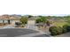 Residential street view showcasing a single-story home with desert landscaping and proximity to green space at 37103 N El Morro Trl, San Tan Valley, AZ 85140