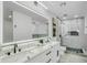 Bright, modern bathroom featuring a double vanity, stylish fixtures, and a glass enclosed shower at 3904 S Butte Ave, Tempe, AZ 85282
