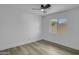 A bright bedroom featuring light wood floors, neutral walls, and a modern ceiling fan at 3904 S Butte Ave, Tempe, AZ 85282