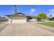 Traditional single-story home with a large driveway, two-car garage, and manicured landscaping at 3904 S Butte Ave, Tempe, AZ 85282