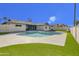 Backyard pool with turf and a view of the home's exterior at 3904 S Butte Ave, Tempe, AZ 85282