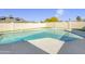 Backyard pool with artificial grass, block fence, and sunny blue sky above at 3904 S Butte Ave, Tempe, AZ 85282