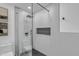 Modern shower featuring gray tile, built-in shelf, and glass door at 3904 S Butte Ave, Tempe, AZ 85282