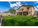 Backyard with lush green grass, decorative rock, and partial patio cover at 396 S 166Th Dr, Goodyear, AZ 85338