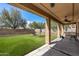 Manicured backyard with patio cover and fire pit at 396 S 166Th Dr, Goodyear, AZ 85338