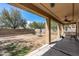 View of the backyard with partial patio cover and decorative rock at 396 S 166Th Dr, Goodyear, AZ 85338