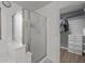 Modern bathroom featuring a glass-enclosed shower and a walk-in closet with built-in shelving at 396 S 166Th Dr, Goodyear, AZ 85338