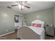 This bedroom features a ceiling fan, closet, and wood floor at 396 S 166Th Dr, Goodyear, AZ 85338
