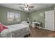 Bedroom with ceiling fan, wood floor, and a desk in the background at 396 S 166Th Dr, Goodyear, AZ 85338