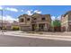 Two-story home boasts a neutral color palette, complemented by a well-manicured front yard and convenient two-car garage at 396 S 166Th Dr, Goodyear, AZ 85338
