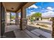 Inviting covered front porch featuring stone columns and desert landscaping at 396 S 166Th Dr, Goodyear, AZ 85338