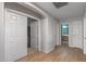 Hallway with wood floors leads to laundry room and bathroom at 396 S 166Th Dr, Goodyear, AZ 85338