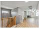 Bright upstairs hallway with wood floors and view of the living room with desk setup at 396 S 166Th Dr, Goodyear, AZ 85338