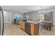 Open kitchen area flows into a living space with a kitchen island and breakfast bar for seamless interaction at 396 S 166Th Dr, Goodyear, AZ 85338